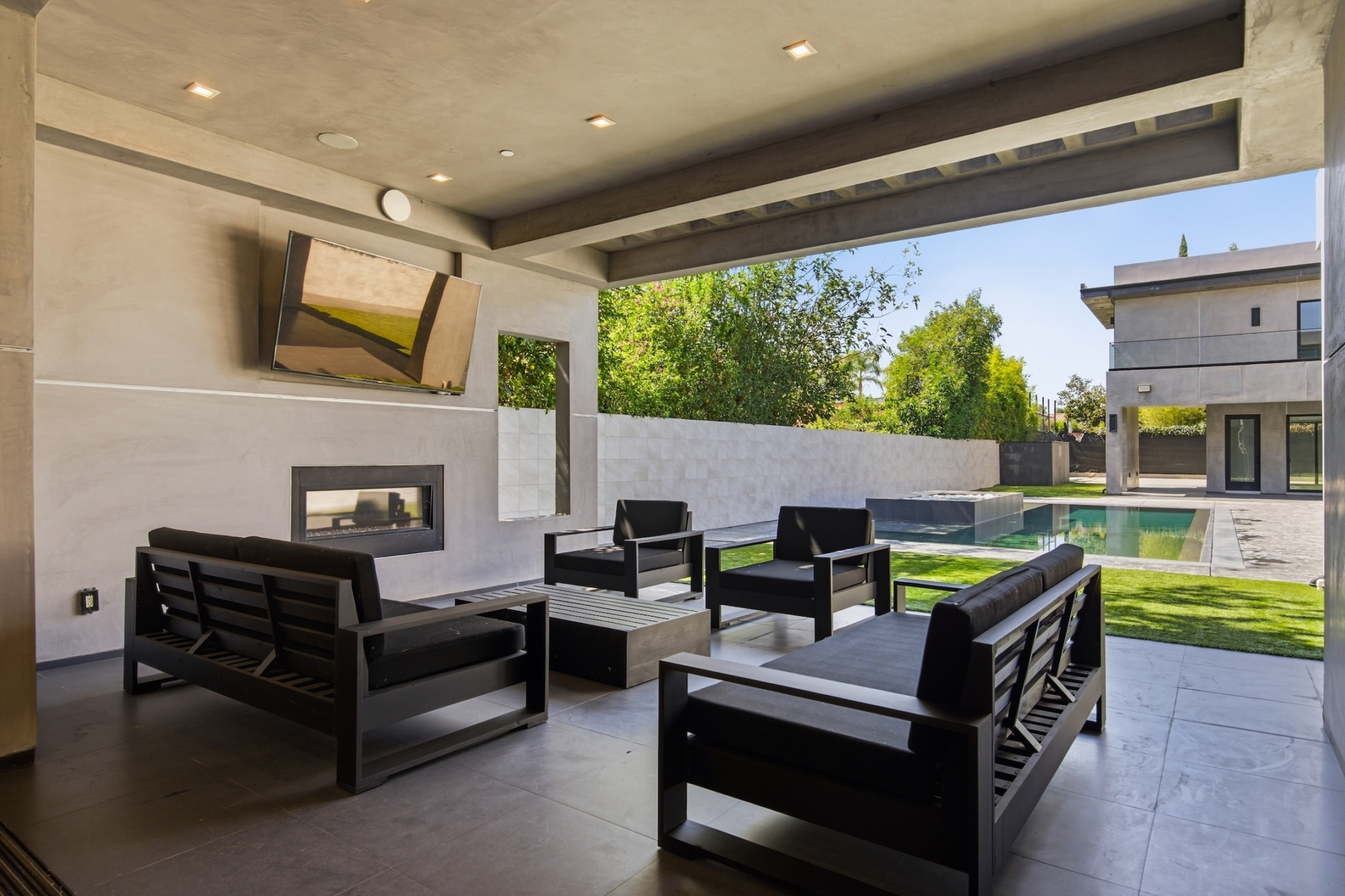 Directly off the main living spaces, a covered patio extends the main house outdoors beneath a deep overhang. 