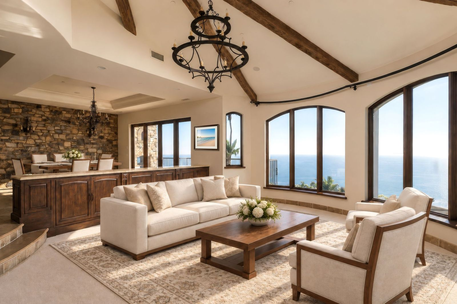 The formal living room settles into one of the home's curved corners, where a series of tall arched windows wraps around the seating area and opens the room to ocean views. 