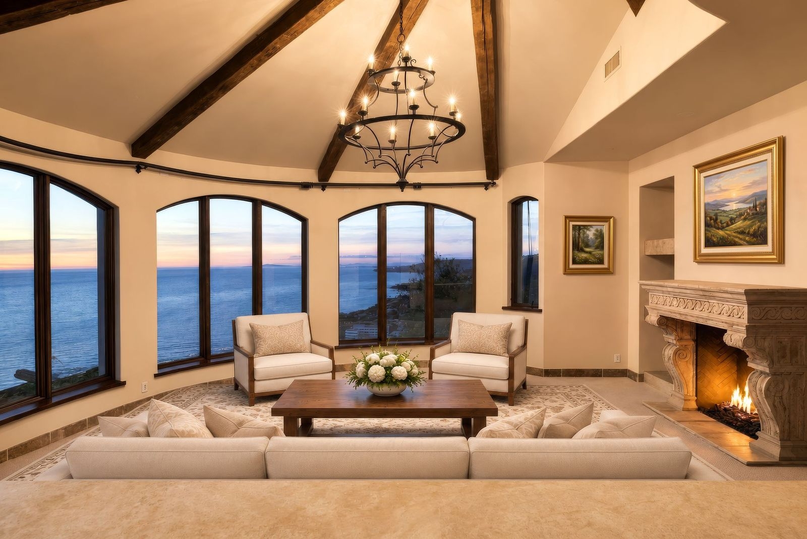 Exposed ceiling beams follow the vaulted roofline overhead, while the fireplace sits along the interior side of the room across from the open lounge space.
