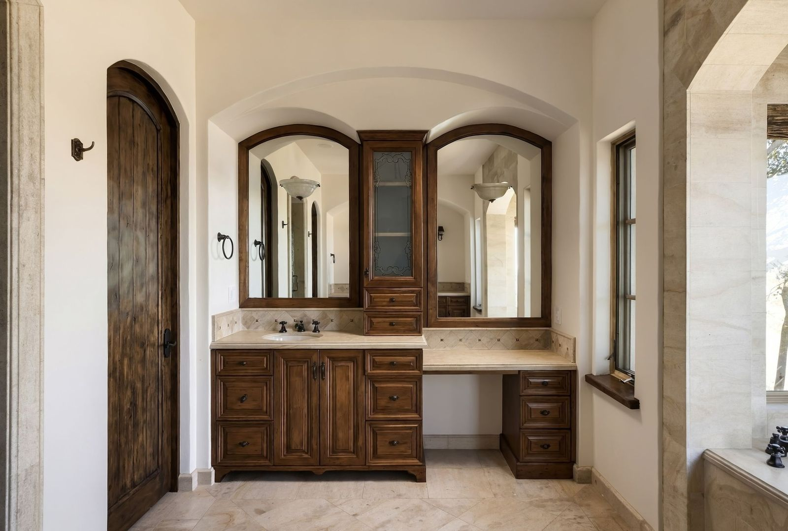 A long wood vanity with a sink and vanity section beneath two mirrors.