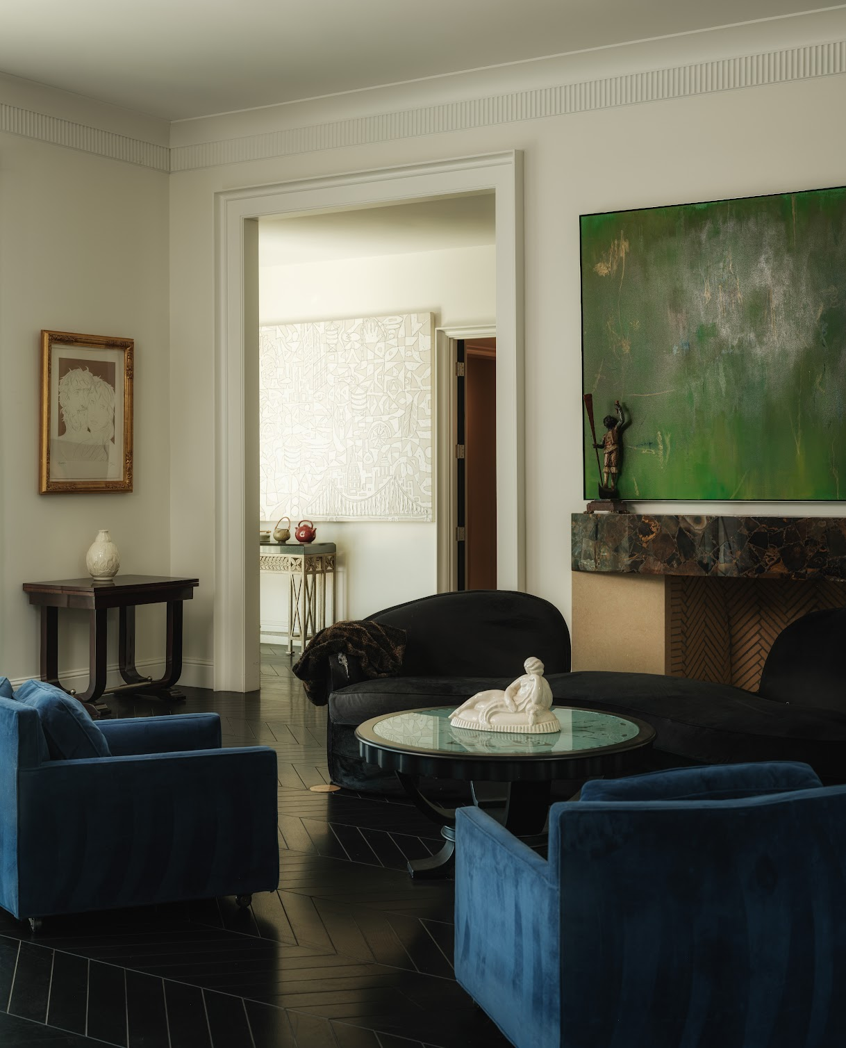 Black and blue suede seating gathers around a fireplace.