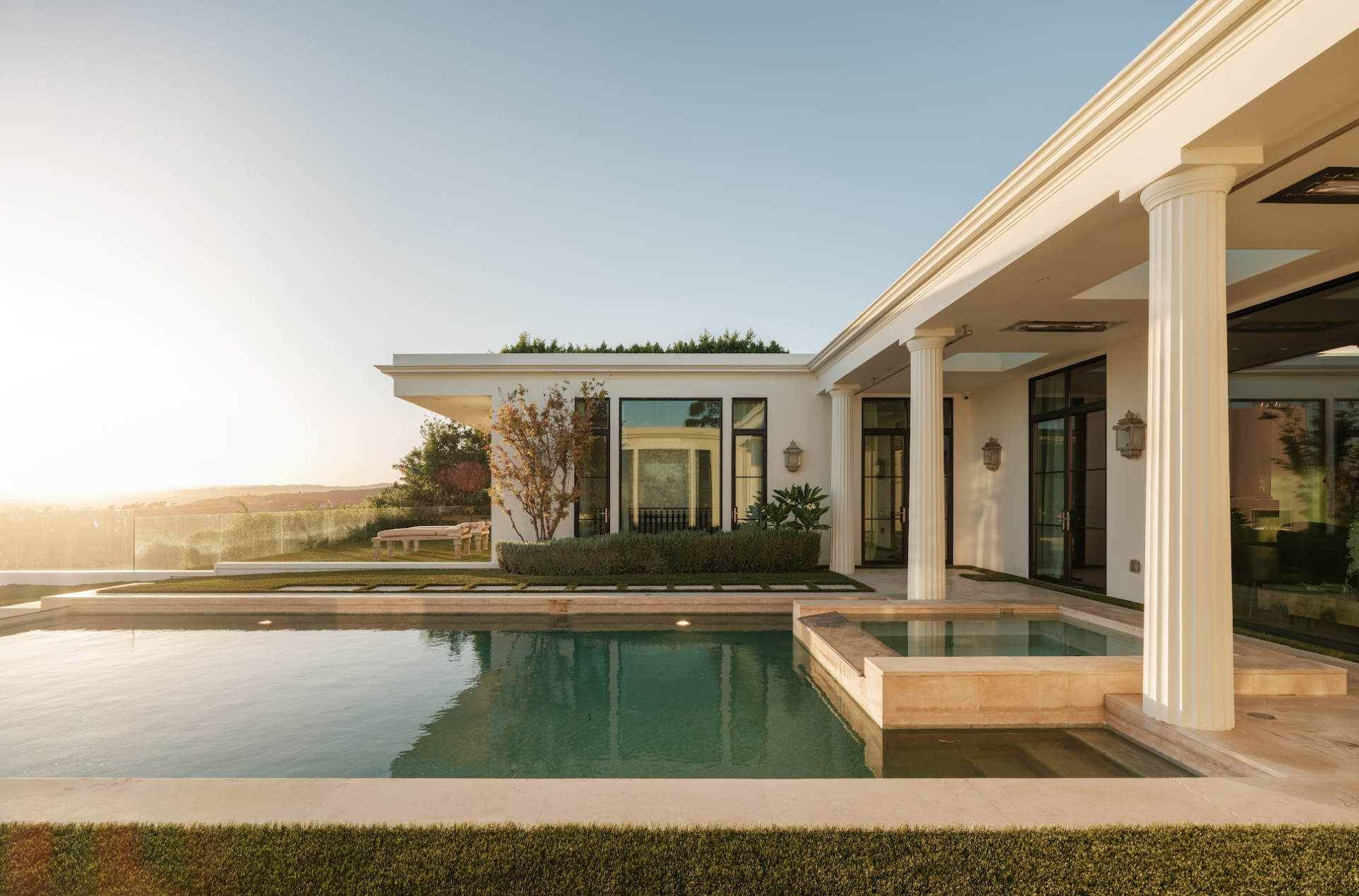 The home opens to a series of covered and open-air terraces around the pool and spa.