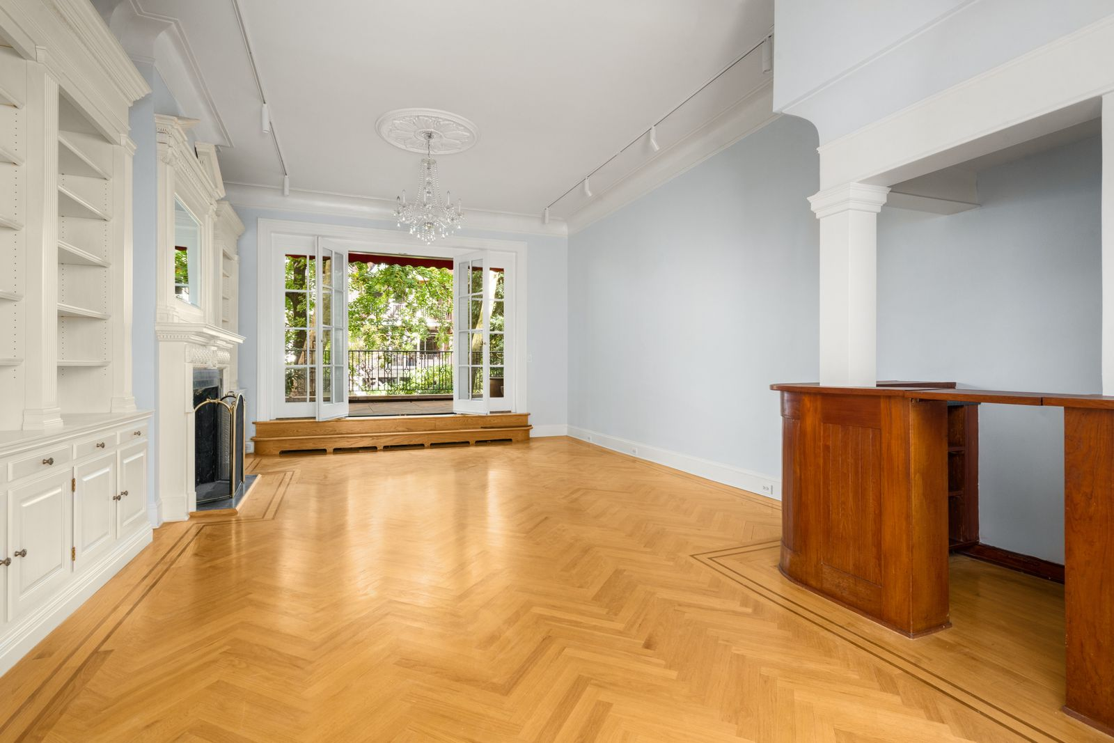 At the back of the parlor level, a small built-in bar marks the entrance to the second sitting room.
