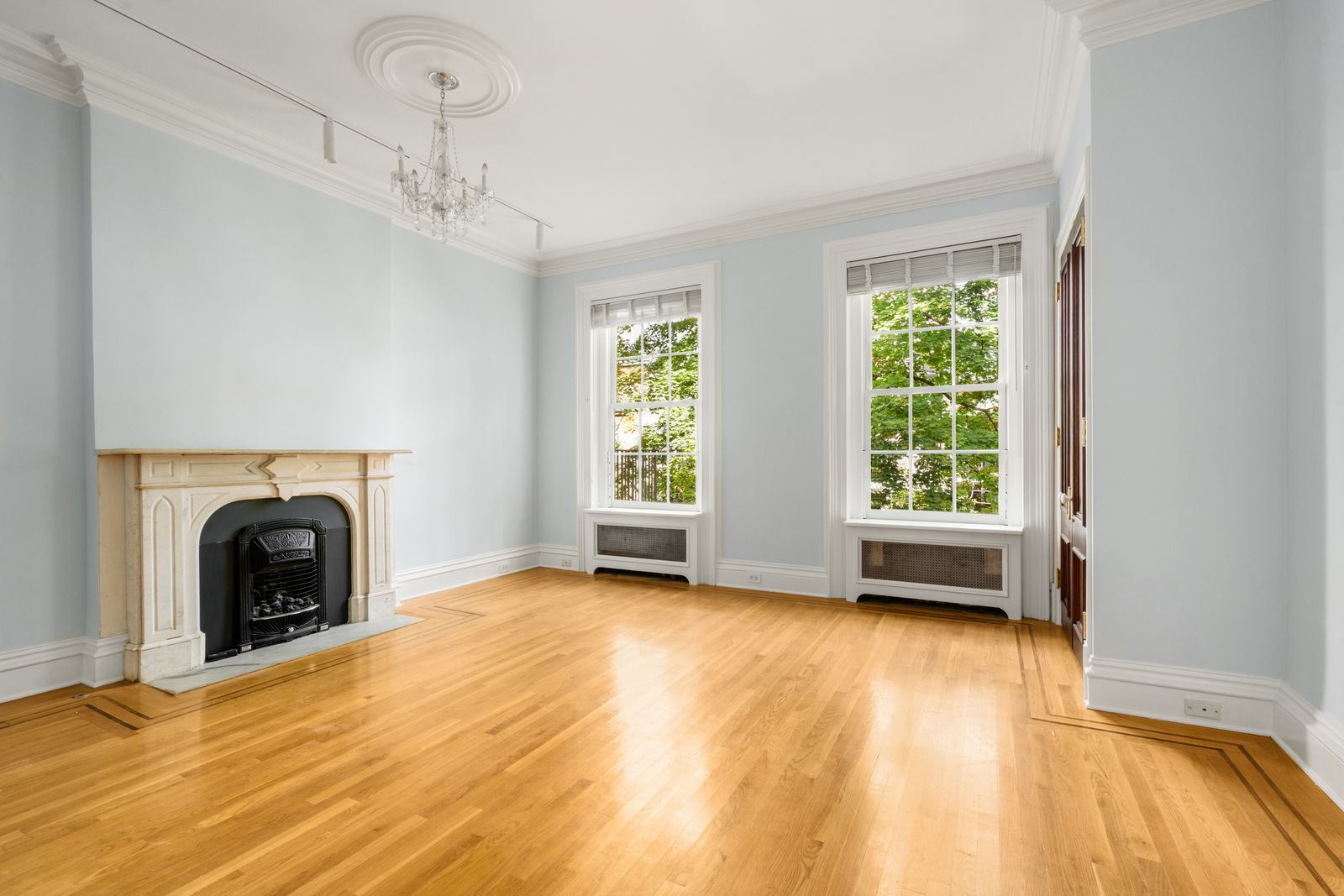 Bedroom with a fireplace set onto one of the pale blue walls.