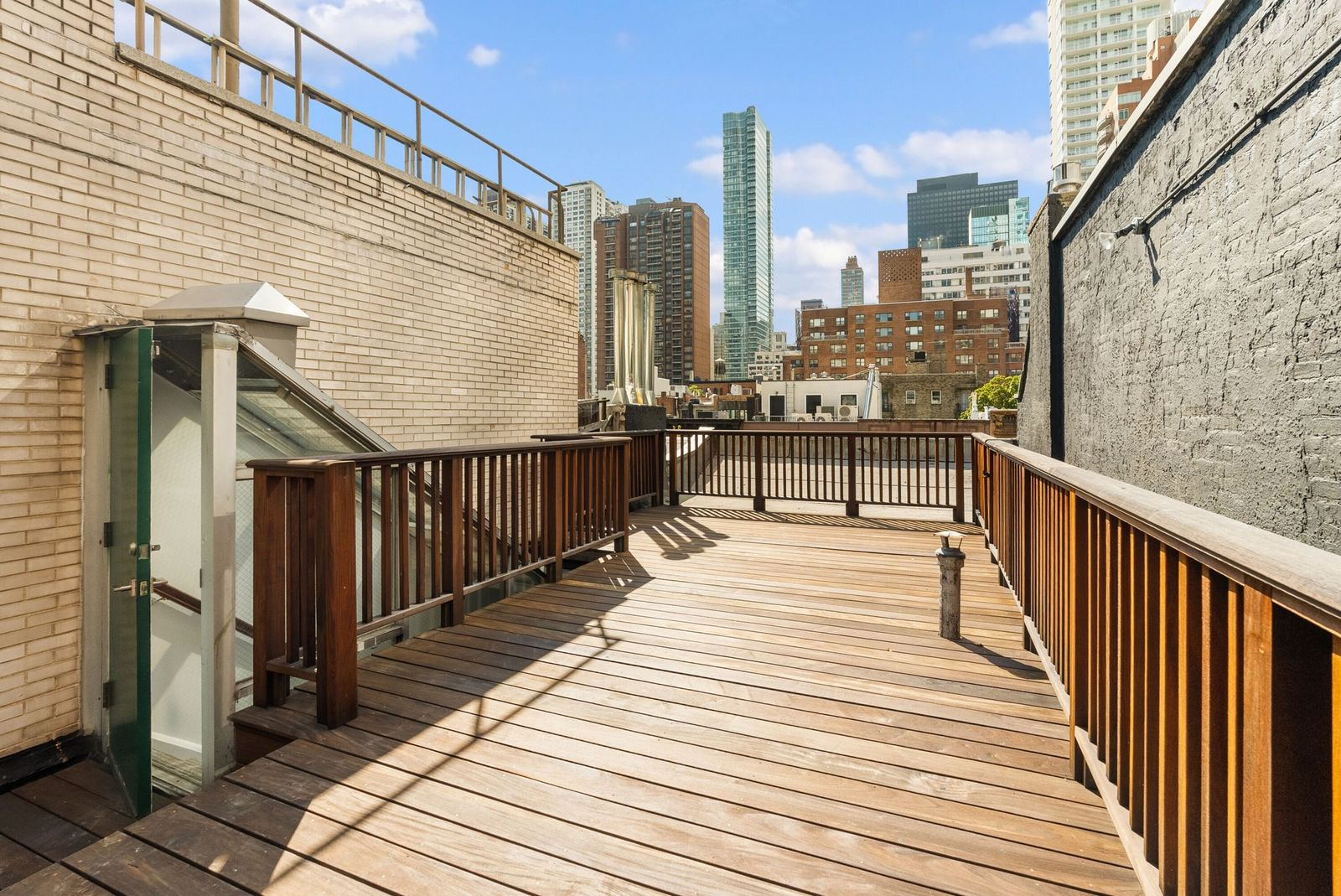 A private rooftop deck adds another outdoor space with open views across the city. 