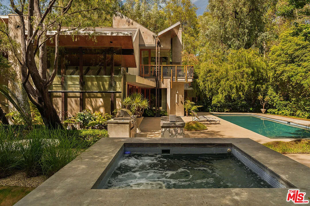 A raised jacuzzi set just off the pool deck.