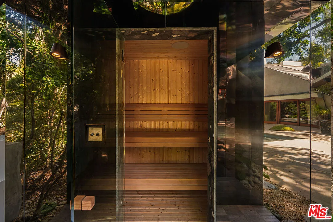 A mirrored sauna is tucked into the landscaping.