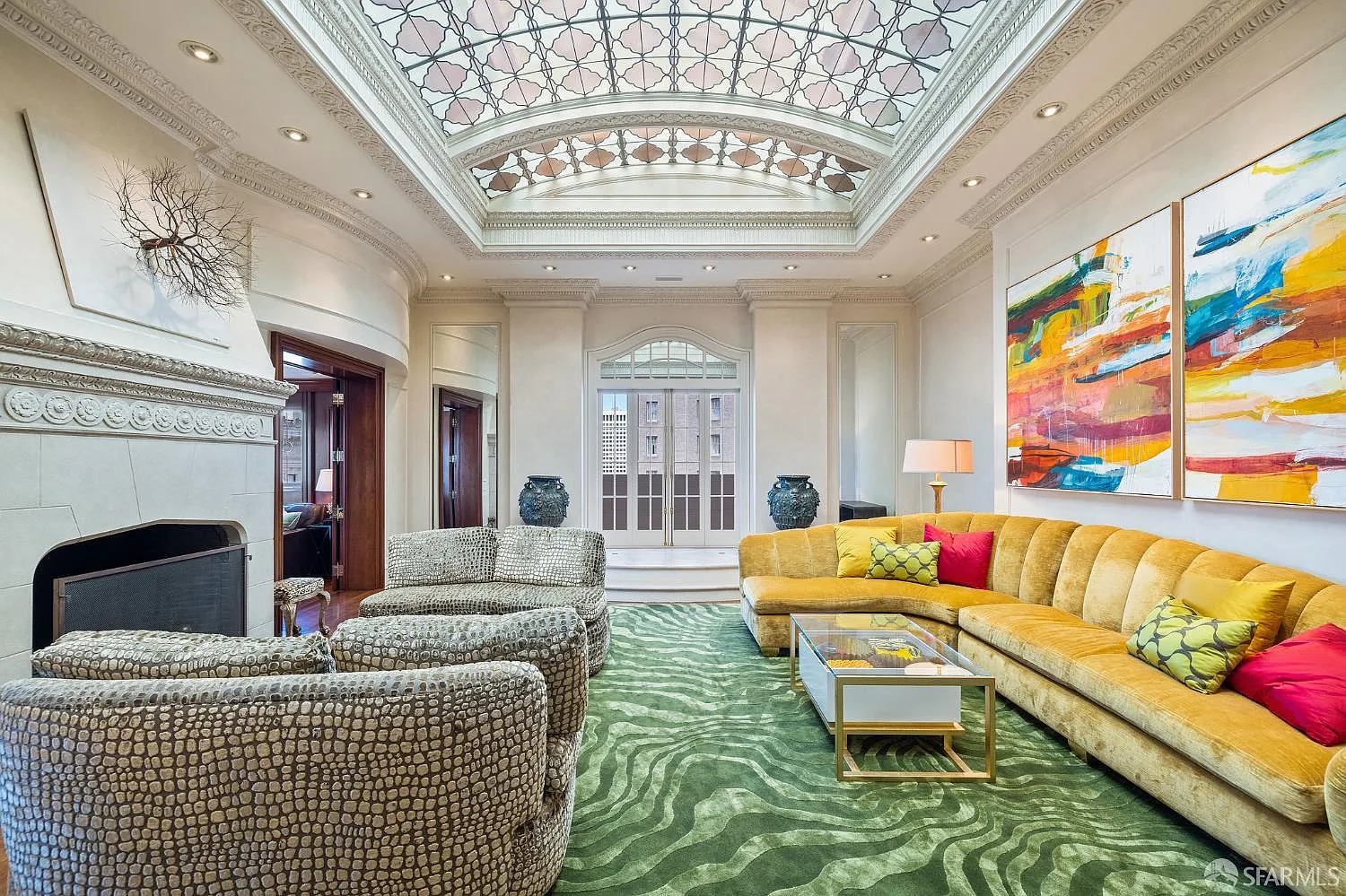 Along the back wall, window-paned doors open the living room directly onto a private balcony.